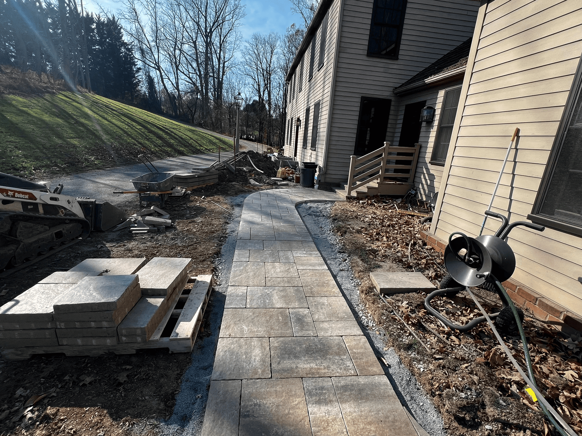 A sidewalk is being built in front of a house.