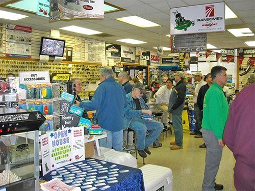 Busy convenience store checkout with customers browsing aisles and waiting in line