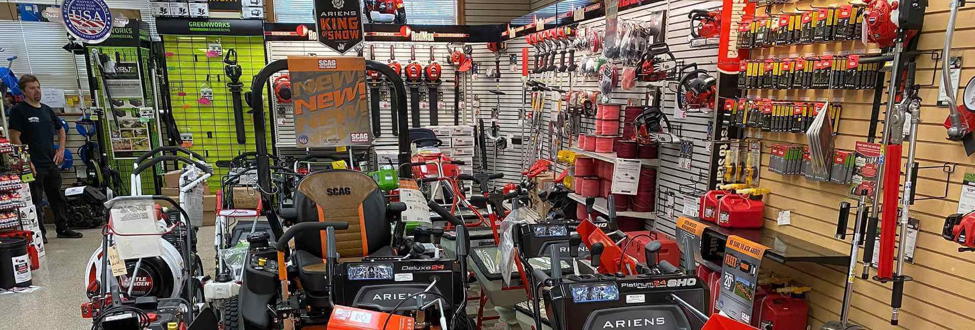 Store aisle with lawn mowers and outdoor power equipment on display