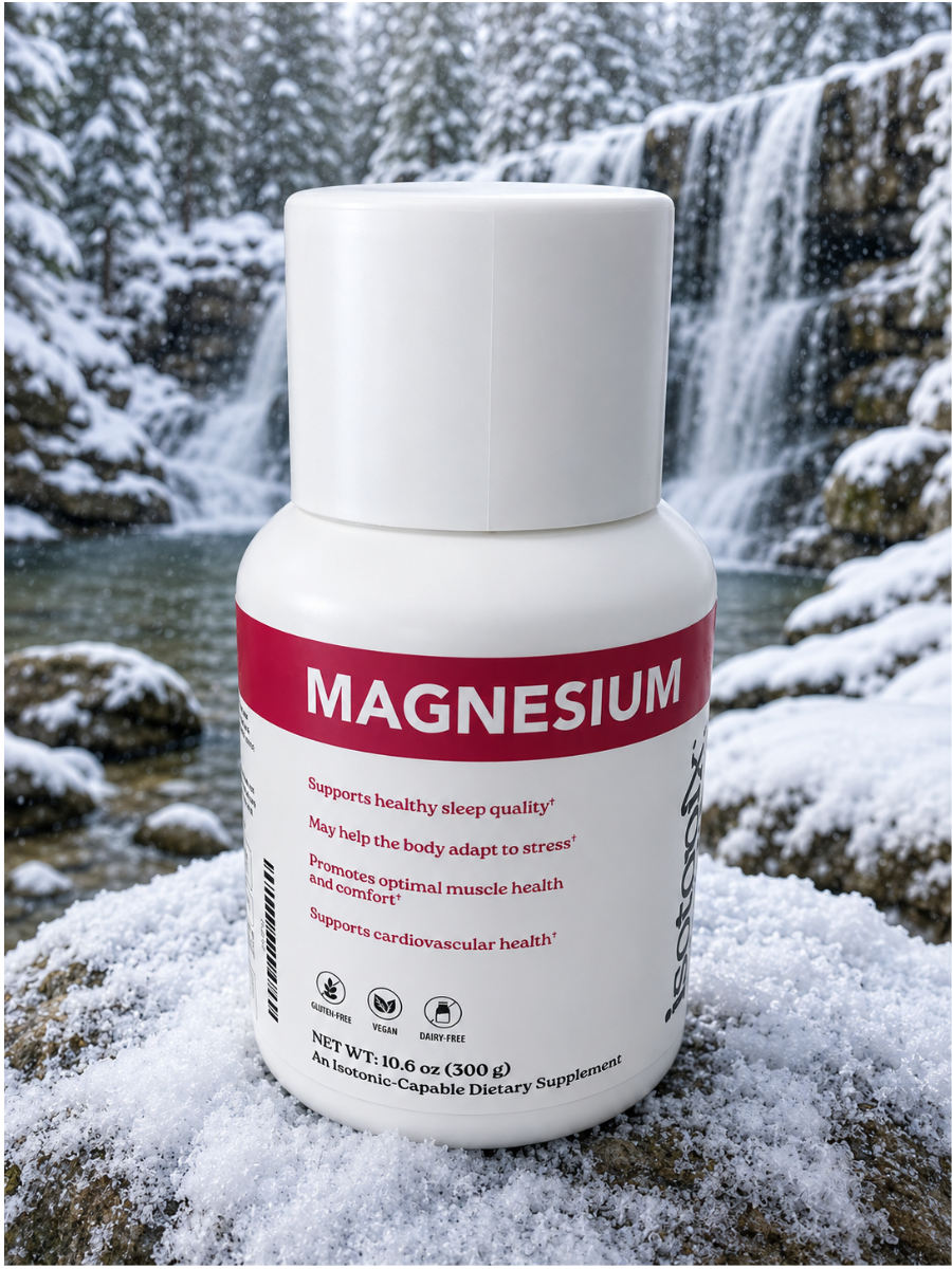 White magnesium supplement bottle in snow with waterfall background