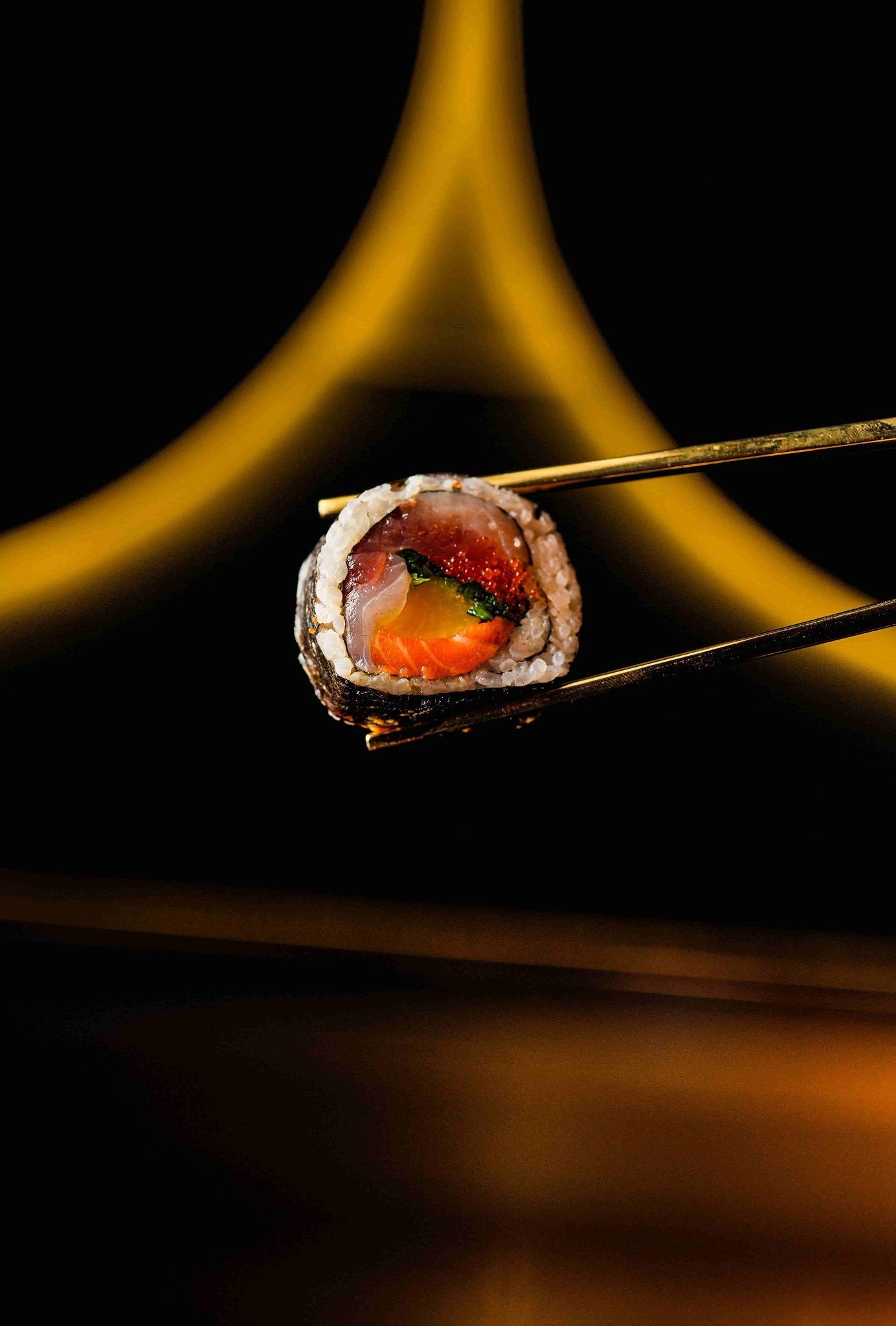 piece of sushi being held withh