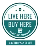 A teal and white circular logo for Elmore County with 