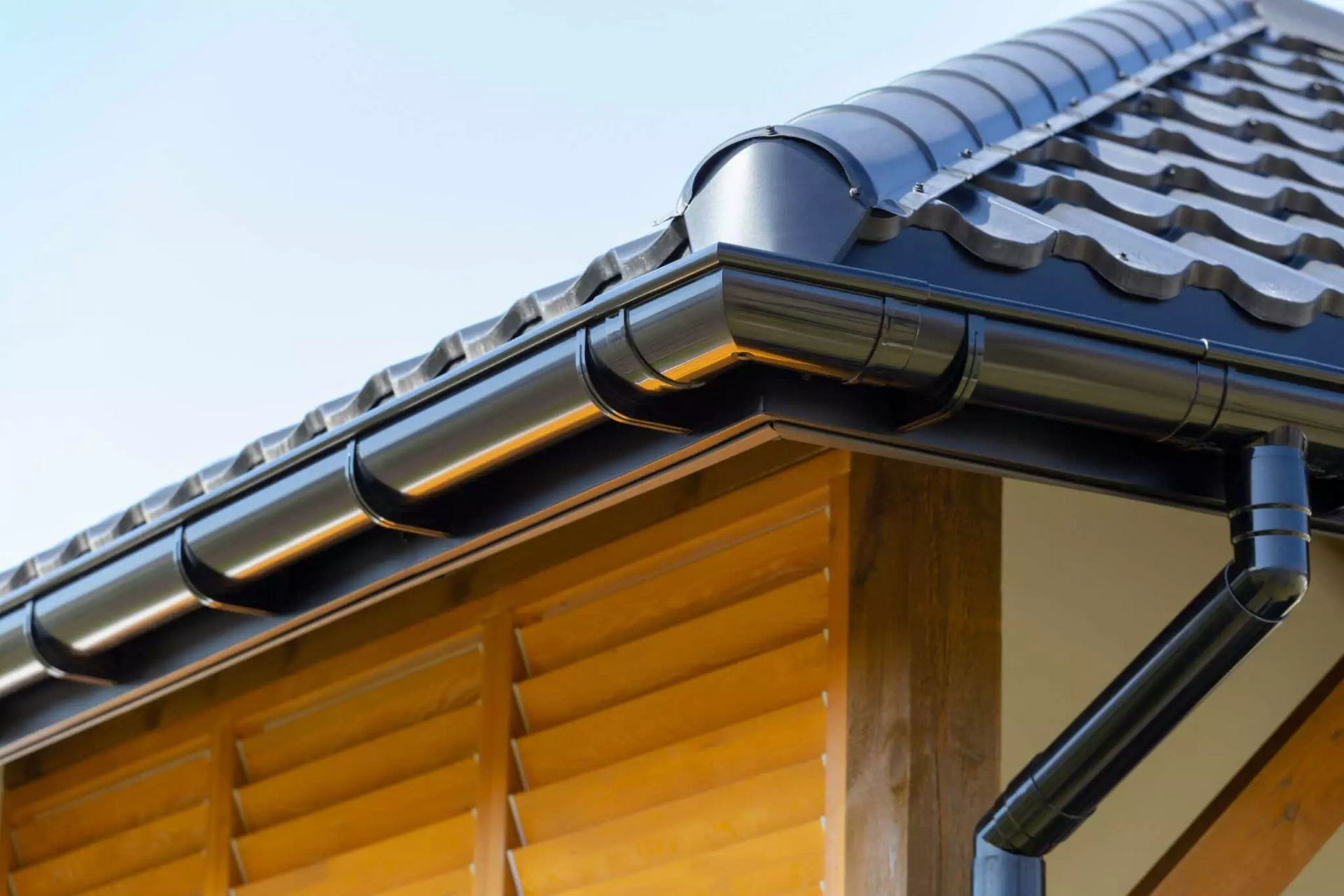 A close up of a gutter on the roof of a house.