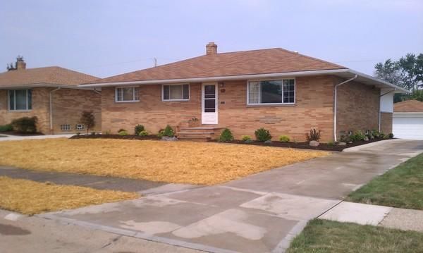 Brick house with landscaping.