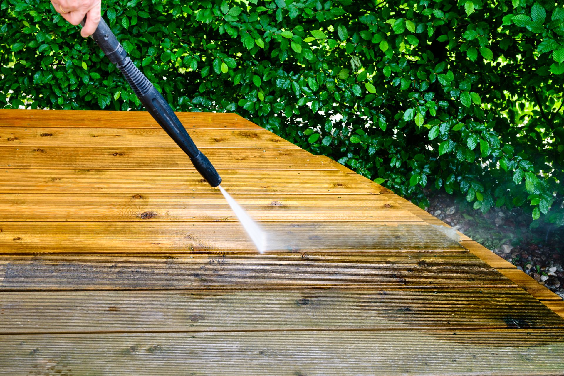 Pressure washing a wooden deck