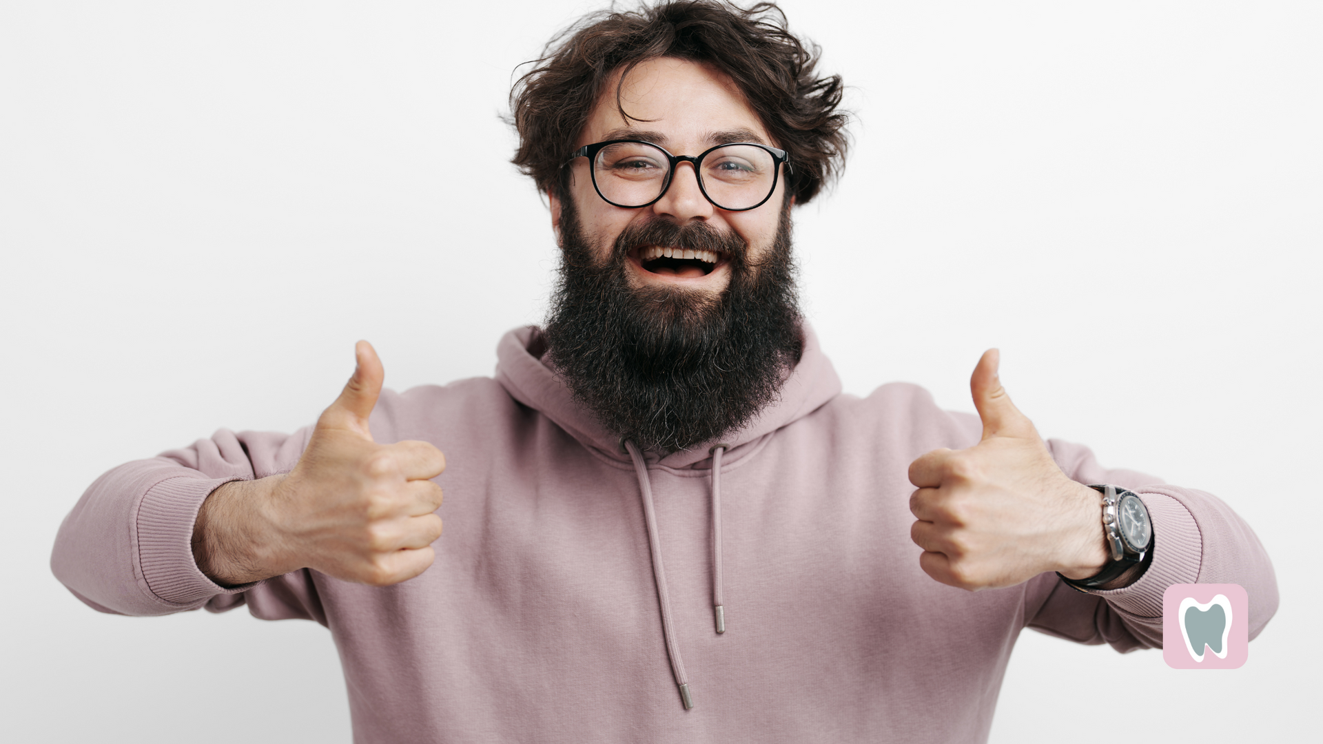 A man with a beard and glasses is giving two thumbs up.