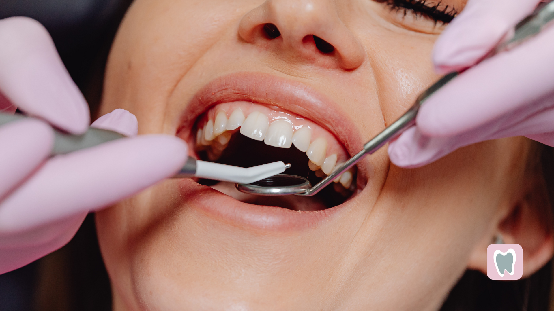 A woman is getting her teeth examined by a dentist.