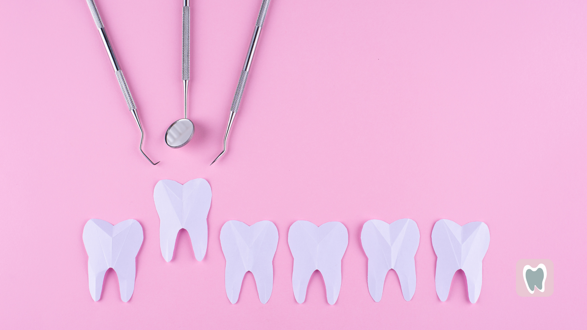 A row of paper teeth and dental instruments on a pink background.