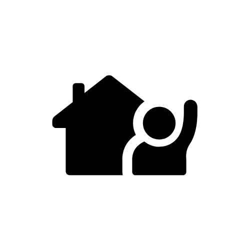 A person is standing in front of a house with their hand up.