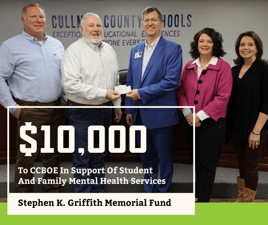 Photo of garrison staff giving $10000 to the CCBOE