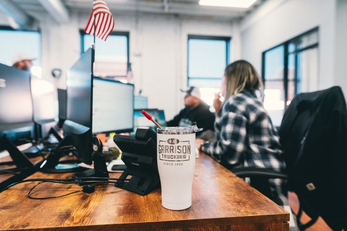 R.E. Garrison office focused on Company Branded Coffee Mug
