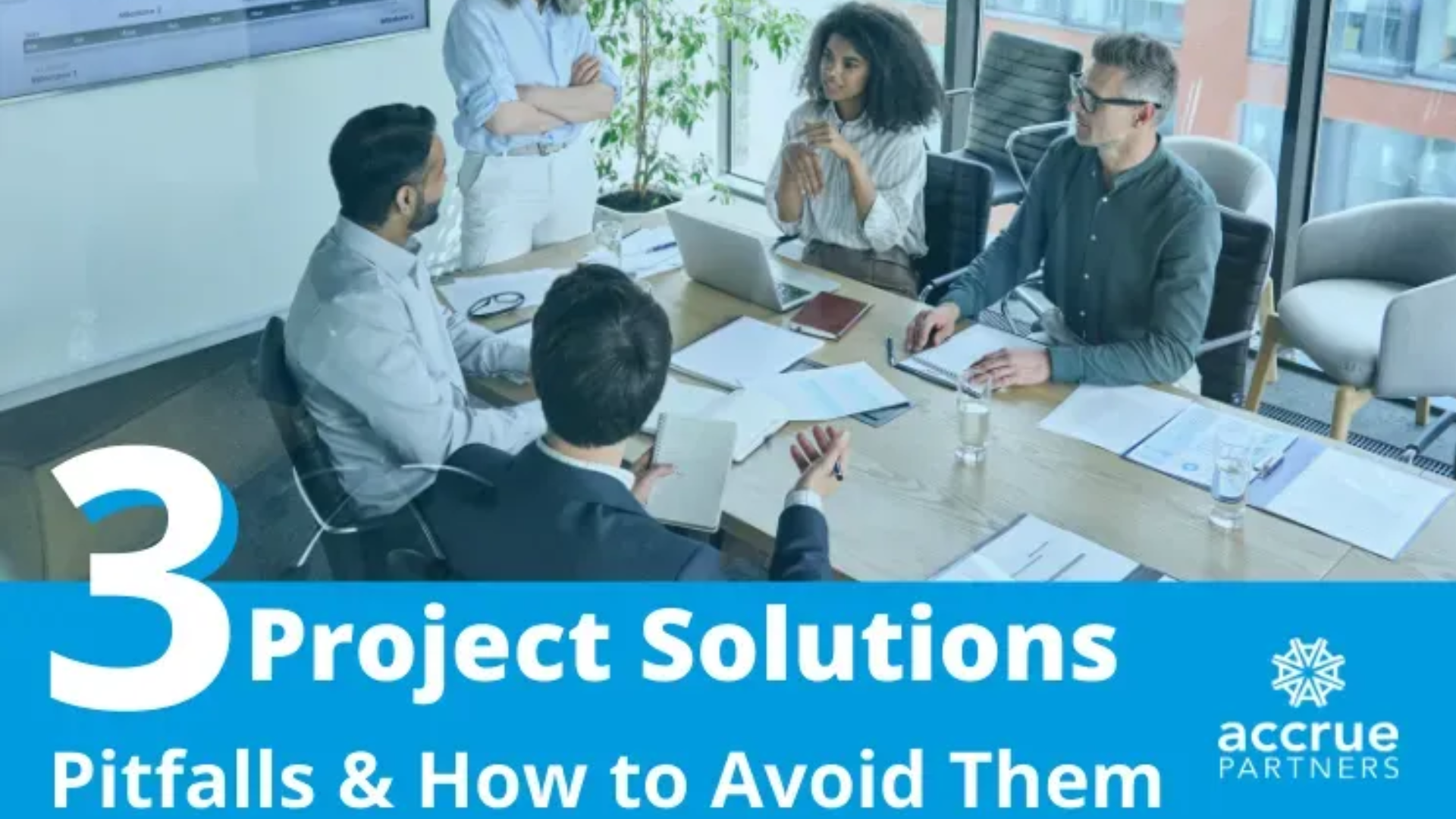 A diverse group of people collaborating in an office setting, with a blue overlay containing the text