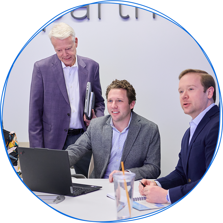 People in a business meeting around a table, using laptops and discussing ideas. Blue and white colors.