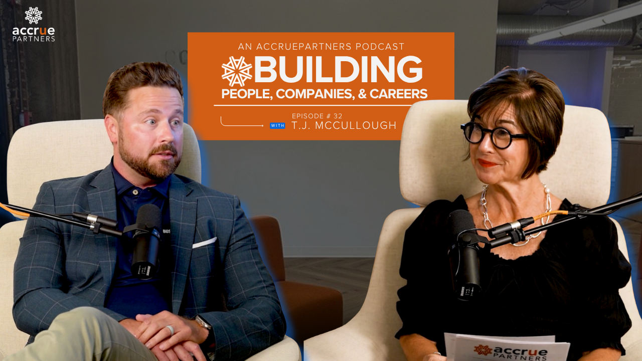 TJ McCullough and Amy Pack seated in front of microphones in the Building People, Companies, and Car