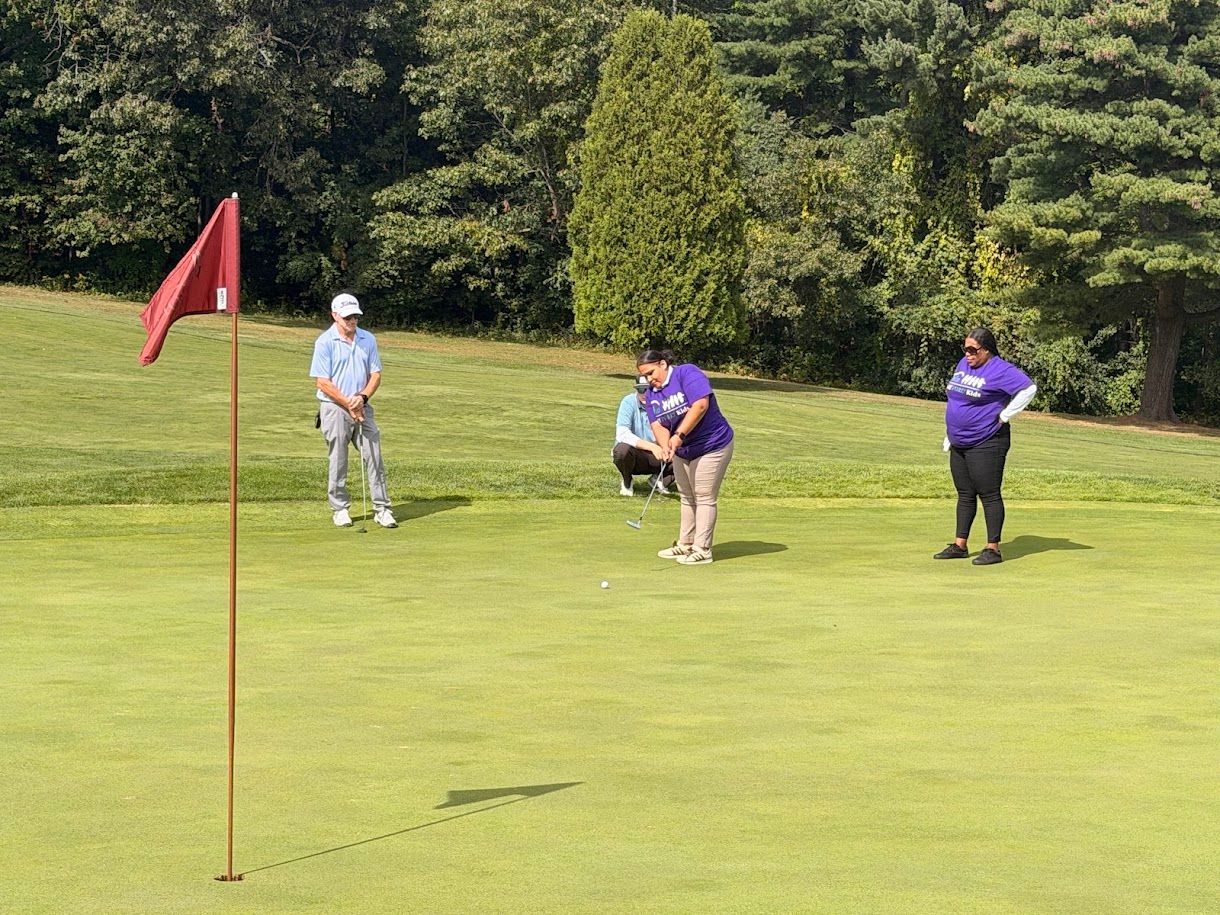 4 golfers playing golf on a sunny day.