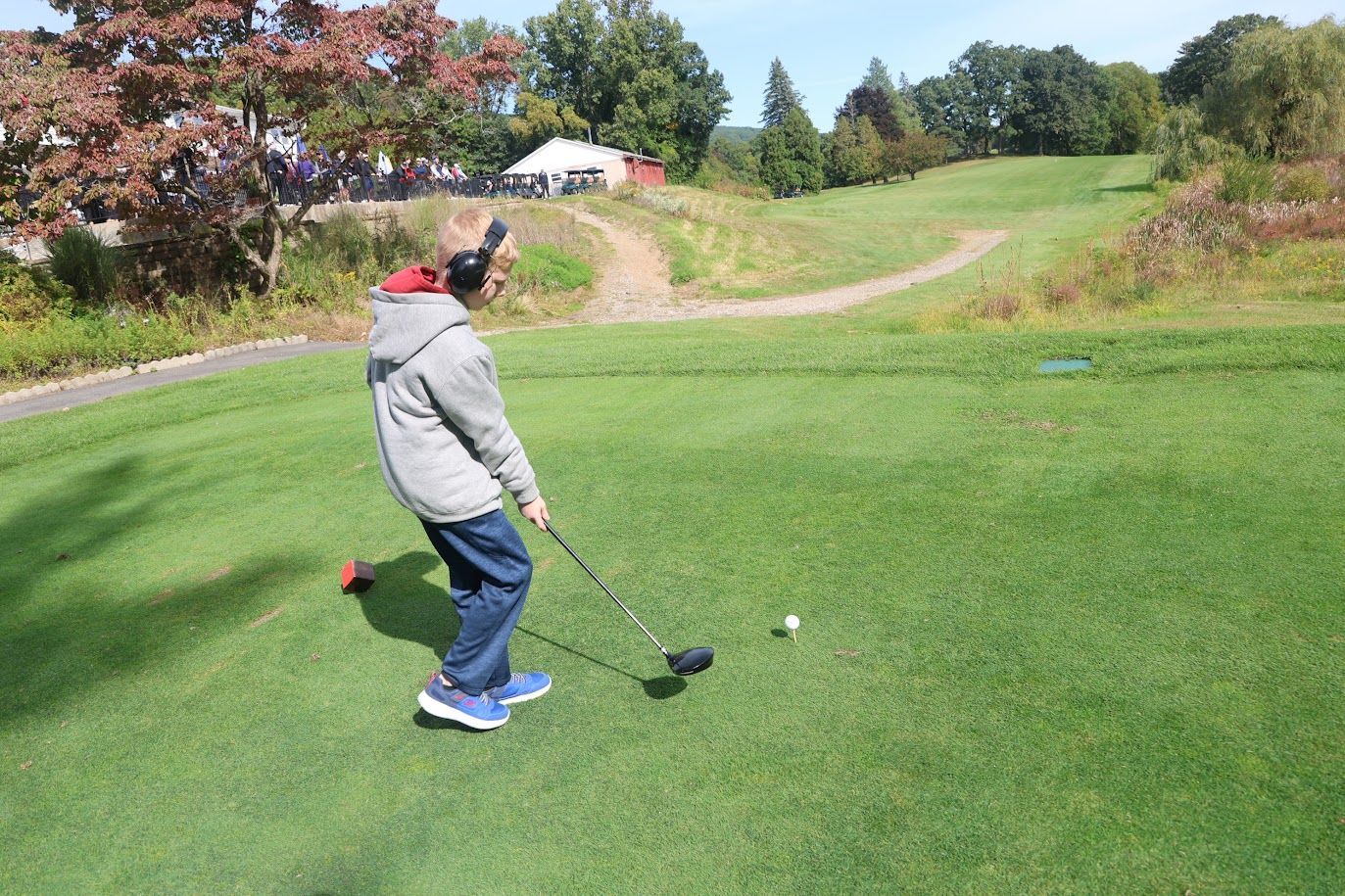 A child prepares to hit a golf ball