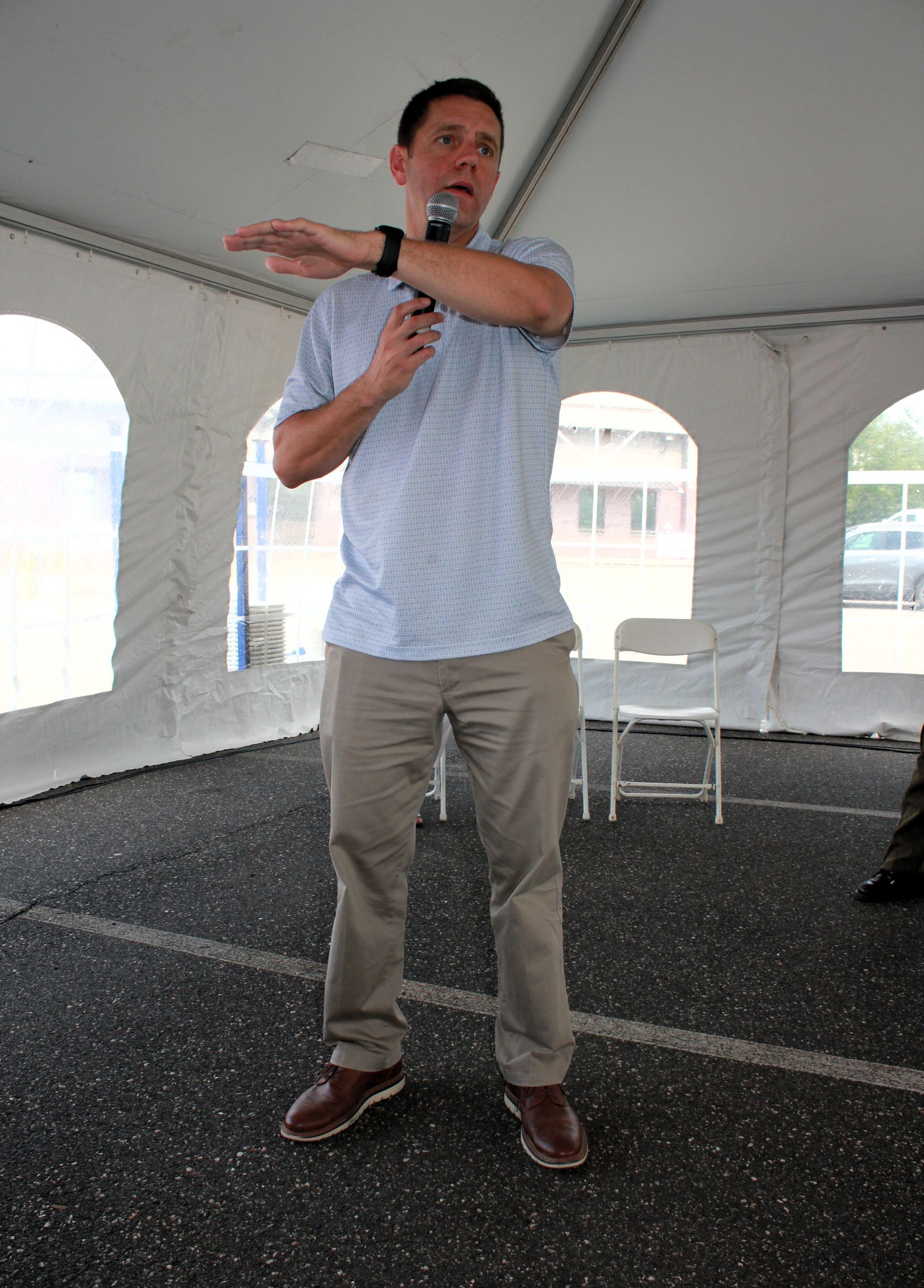 Senator Velis talks into a microphone while giving a speech for the International Overdose Awareness Day event at BHN.