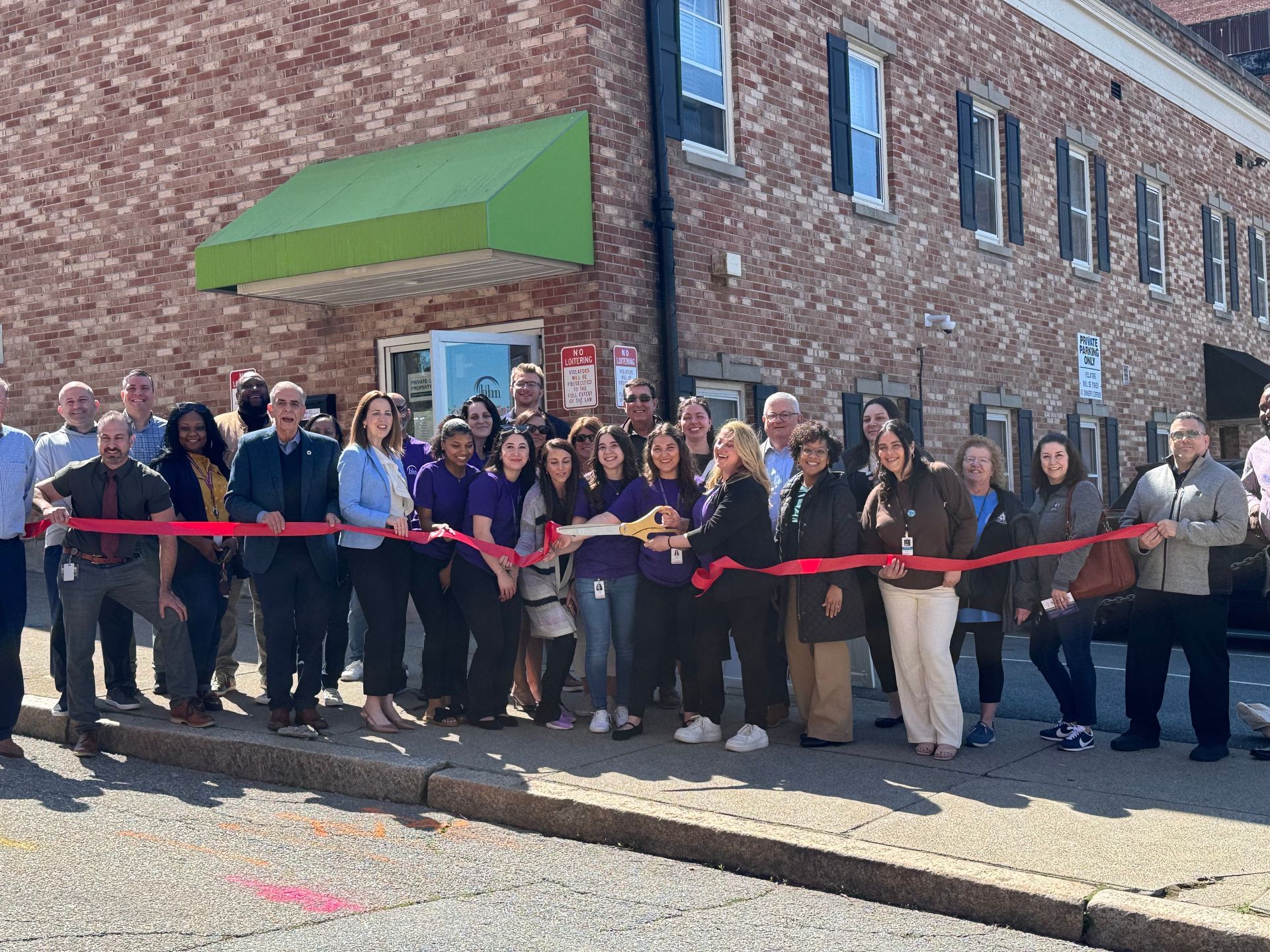 Staff and community members gather for the ribbon cutting at the BHN Fall River Abilities Center grand opening.