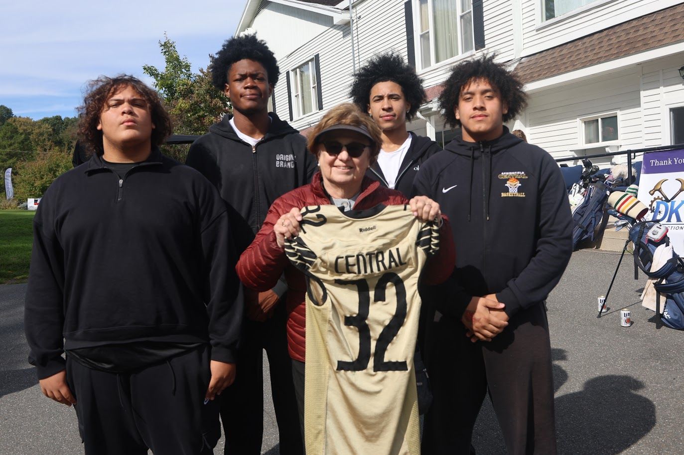 Kathy Wilson holds up a jersey that says 