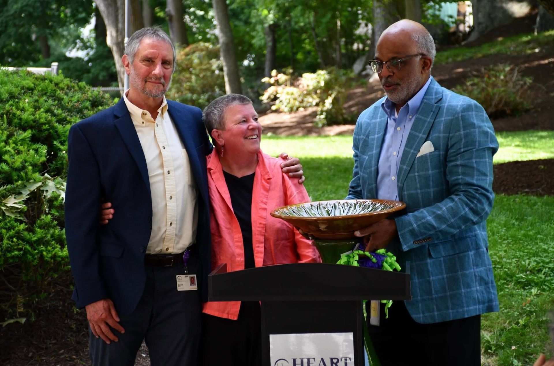Steve Winn BHN President & CEO and Tony Boswell, BHN Sr. VP gift Rose Evans, BHN Sr. VP a bird bath.
