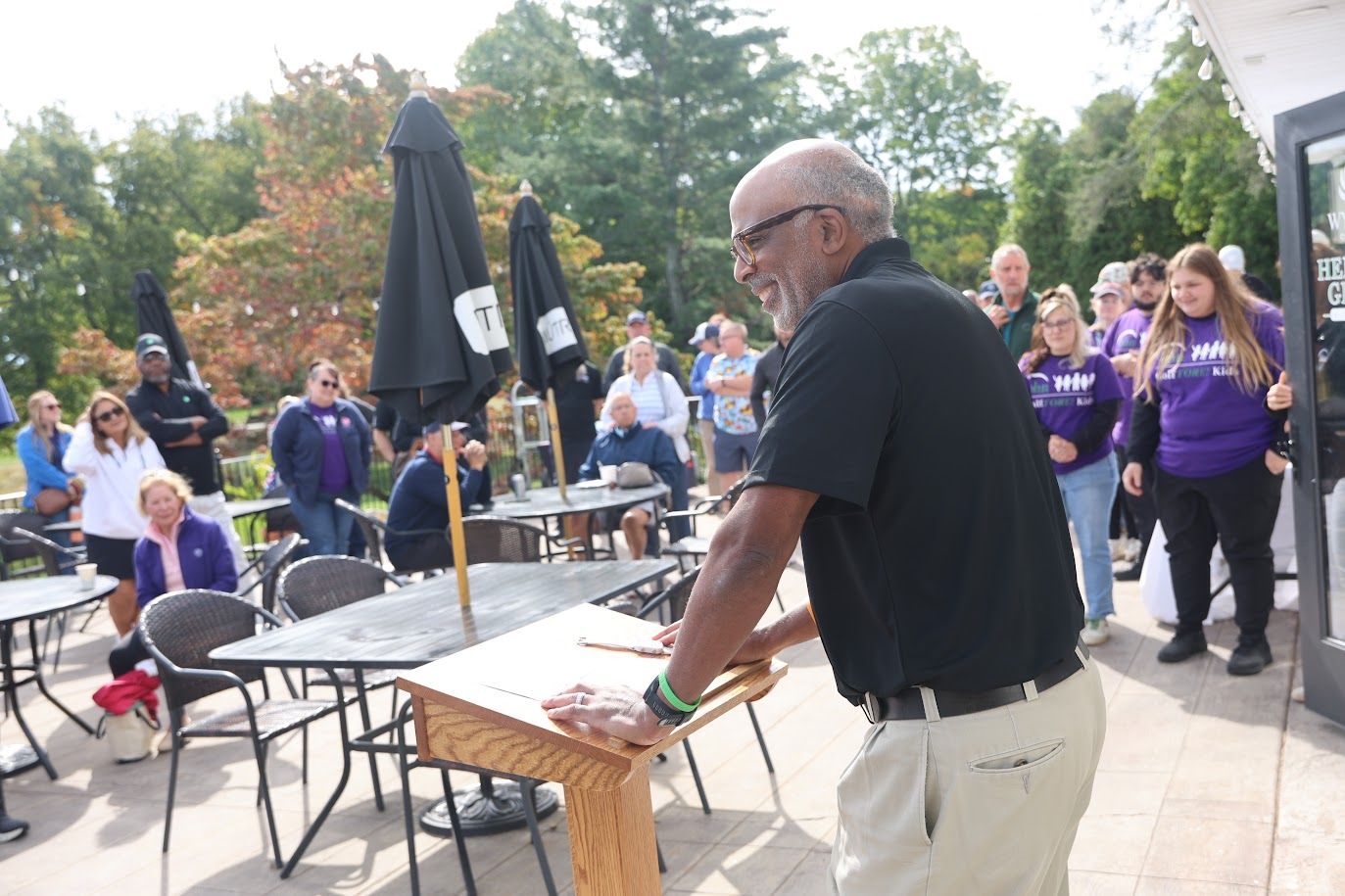 Tony Boswell delivers a speech outside at the Golf FORE Kids fundraiser