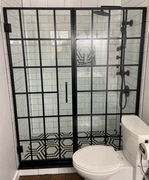 A bathroom with a walk in shower and a toilet