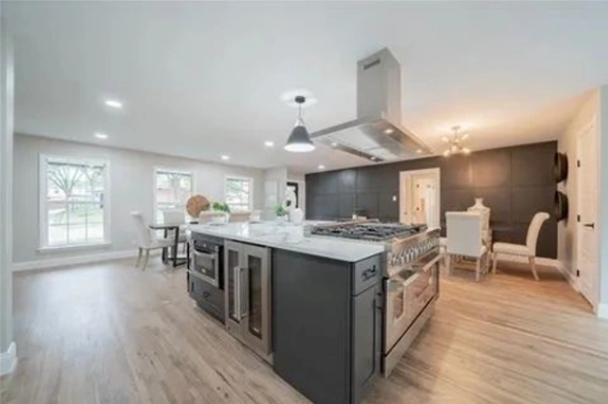 A kitchen with a large island in the middle of the room.