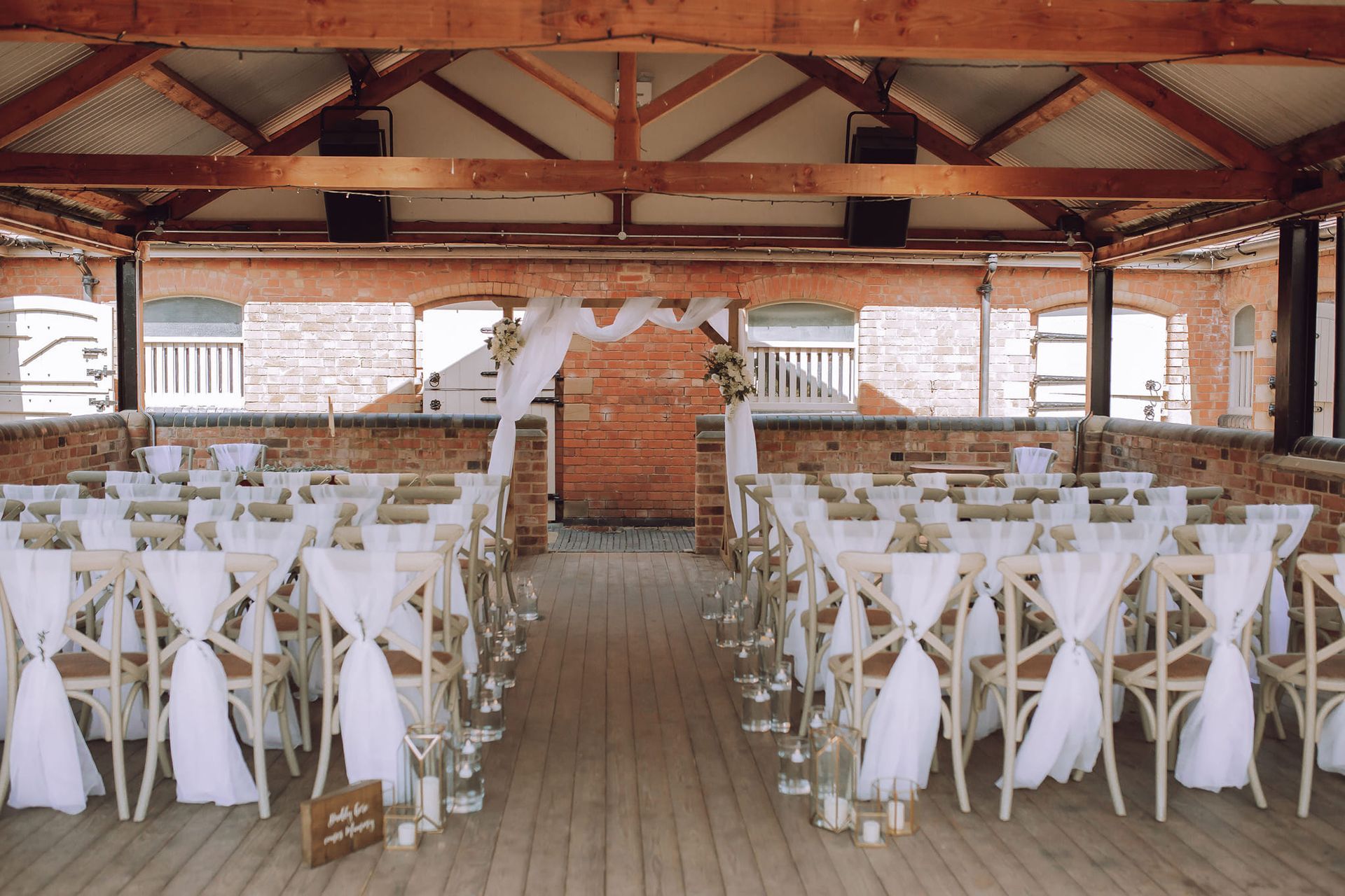 white chair drapes, wedding ceremony, aisle candles