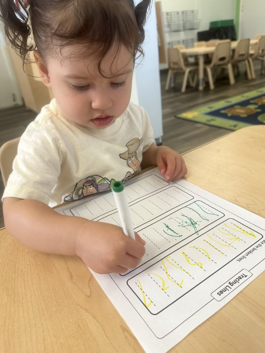 A Little Girl Writing on a Piece of Paper — Brentwood, CA — Baby Yale Academy
