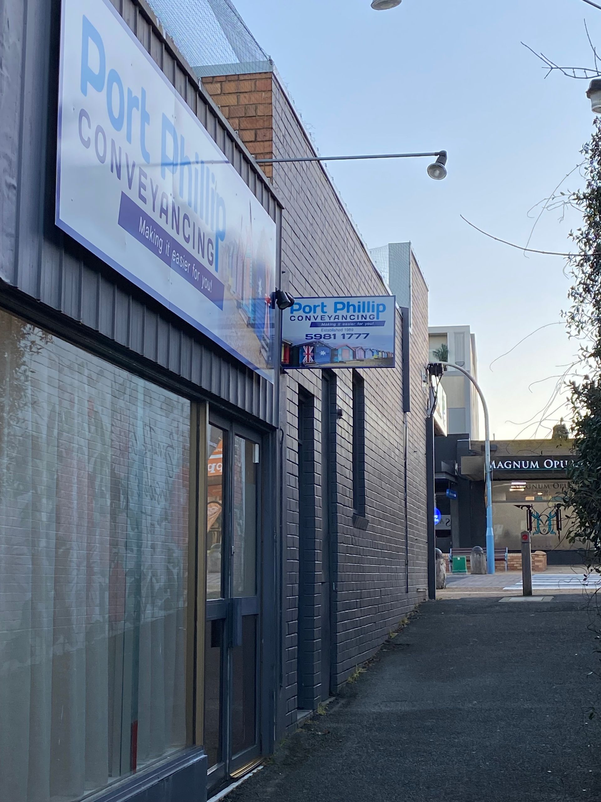 A sign on the side of a building says port philip