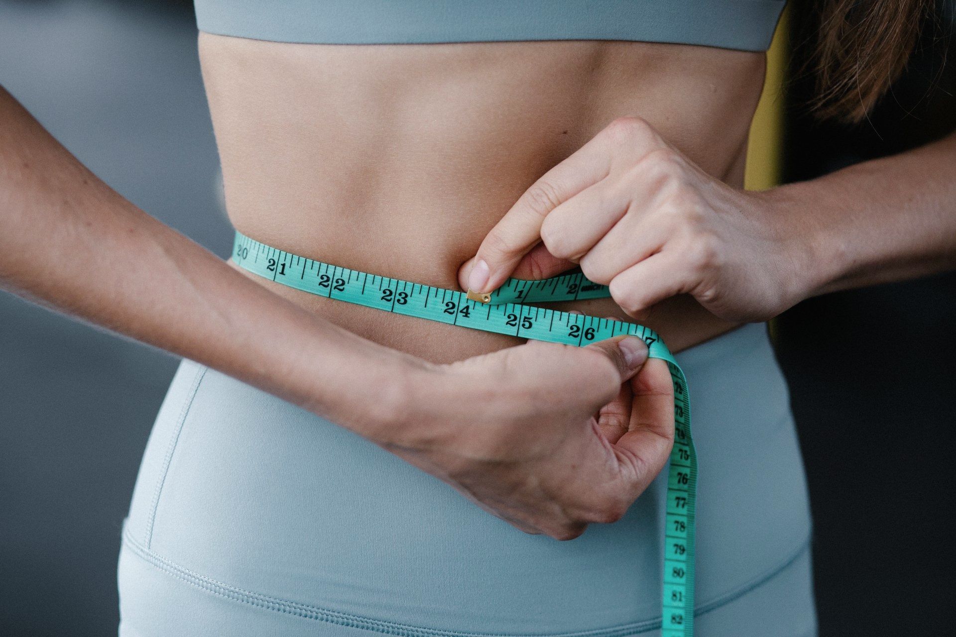 Woman Measuring Her Waist