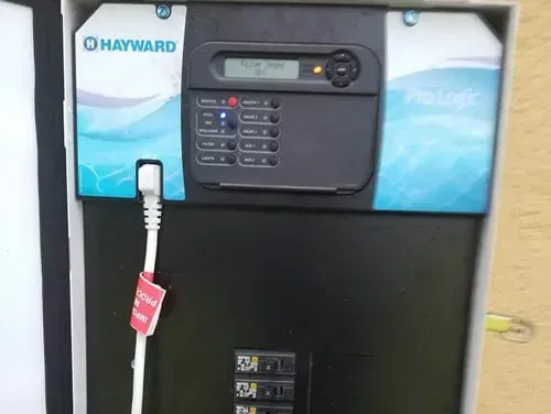 A hayward swimming pool remote control is sitting in a box.