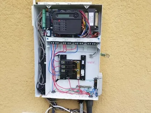 A white box with a lot of wires coming out of it