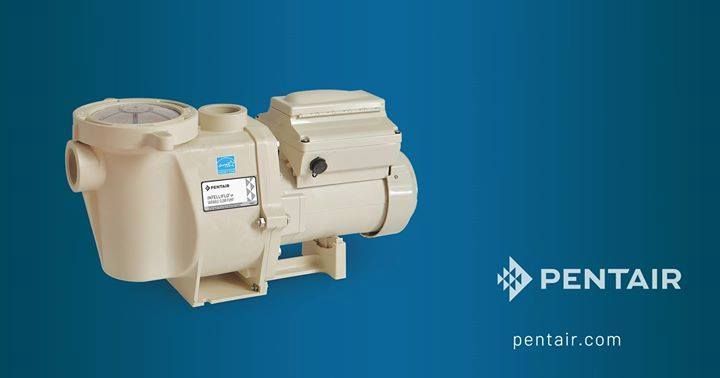 A white swimming pool pump is sitting on a blue surface. A white swimming pool pump is sitting on a blue surface.