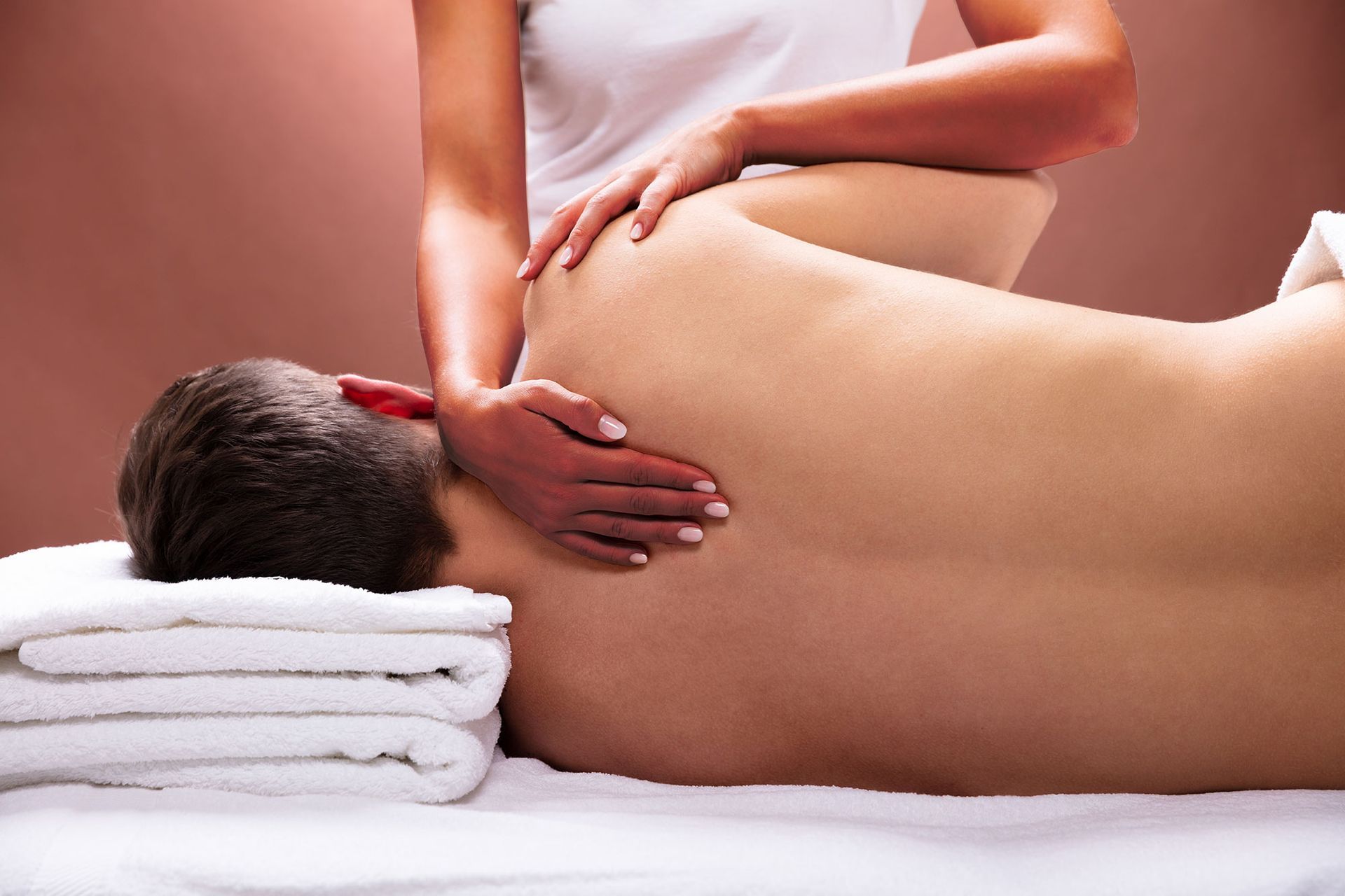 A man is getting a massage from a woman