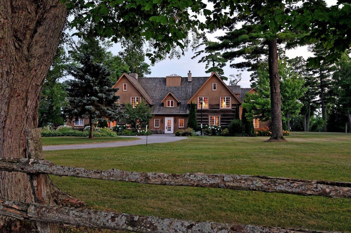 A large house with a wooden fence in front of it