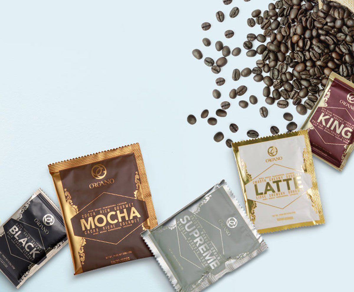 A variety of Organo coffee packets and coffee beans on a table.