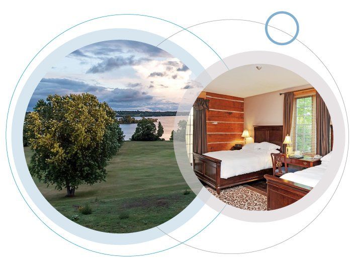 A hotel room with two beds and a tree in the background
