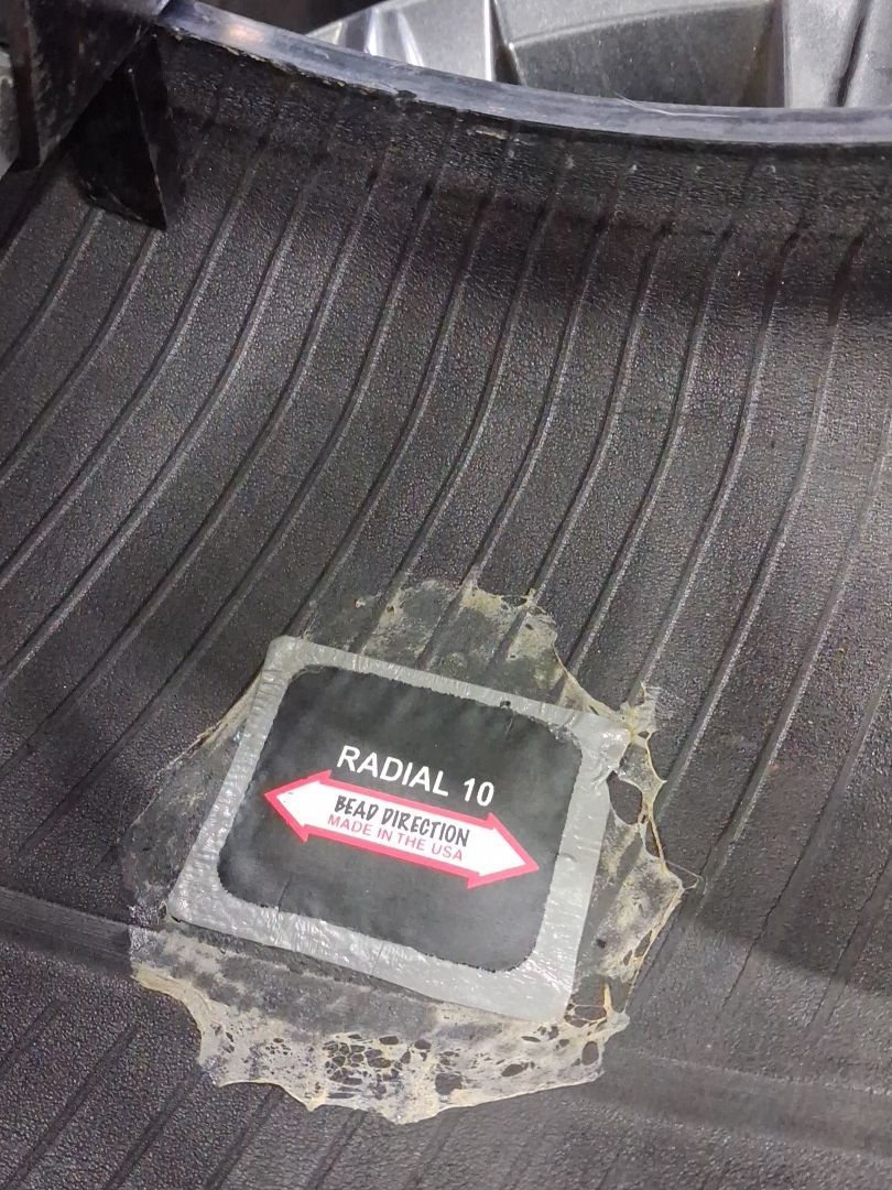 Damaged interior car panel with a small red-and-white warning label