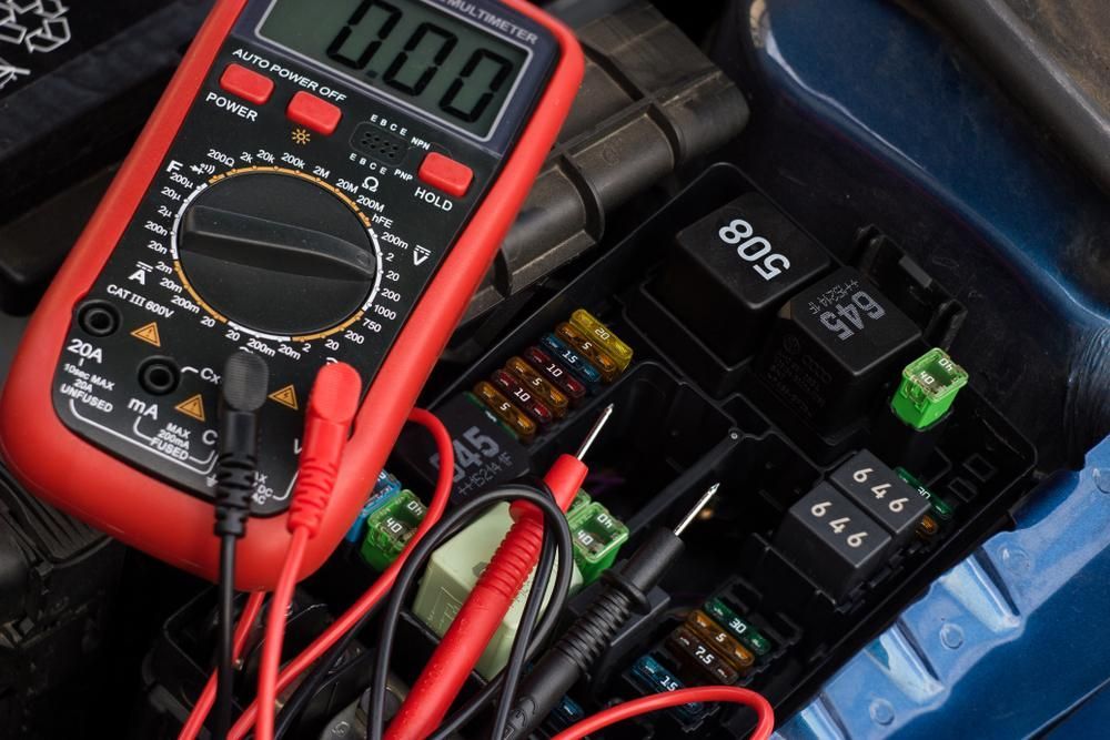 A Digital Multimeter Is Sitting on Top of A Car Fuse Box — Stellar Test and Tag in Gunnedah, NSW