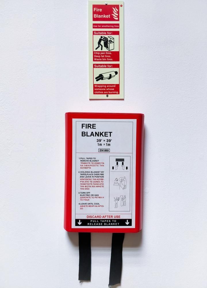 A Red Fire Blanket Is Hanging on A White Wall — Stellar Test and Tag in Gunnedah, NSW
