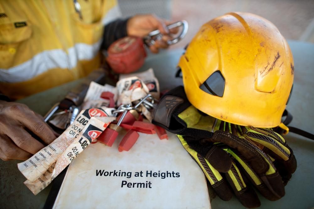 A Person Is Sitting at A Table with A Helmet, Gloves, and A Working at Heights Permit — Stellar Test and Tag in Gunnedah, NSW
