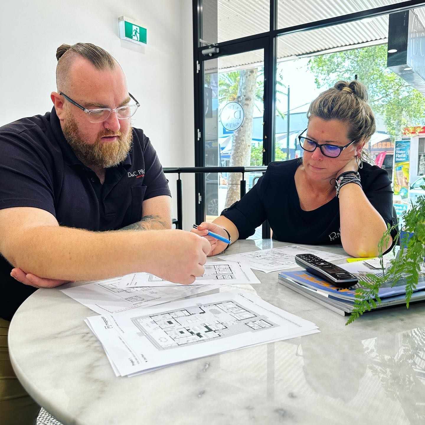 Two People Reviewing Architectural Plans — D&C Projects in Tamworth, NSW