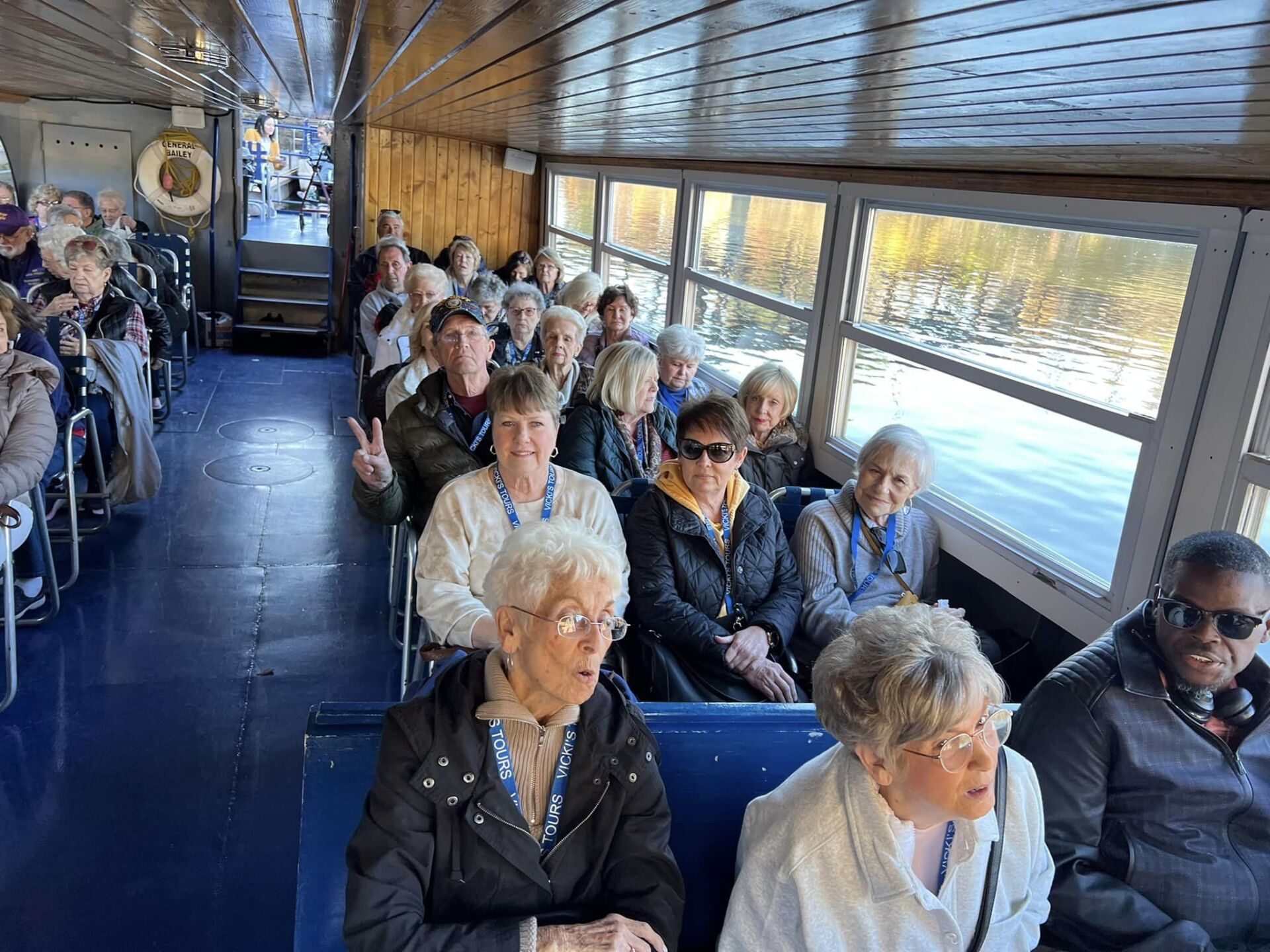 a group of people are sitting on a boat .