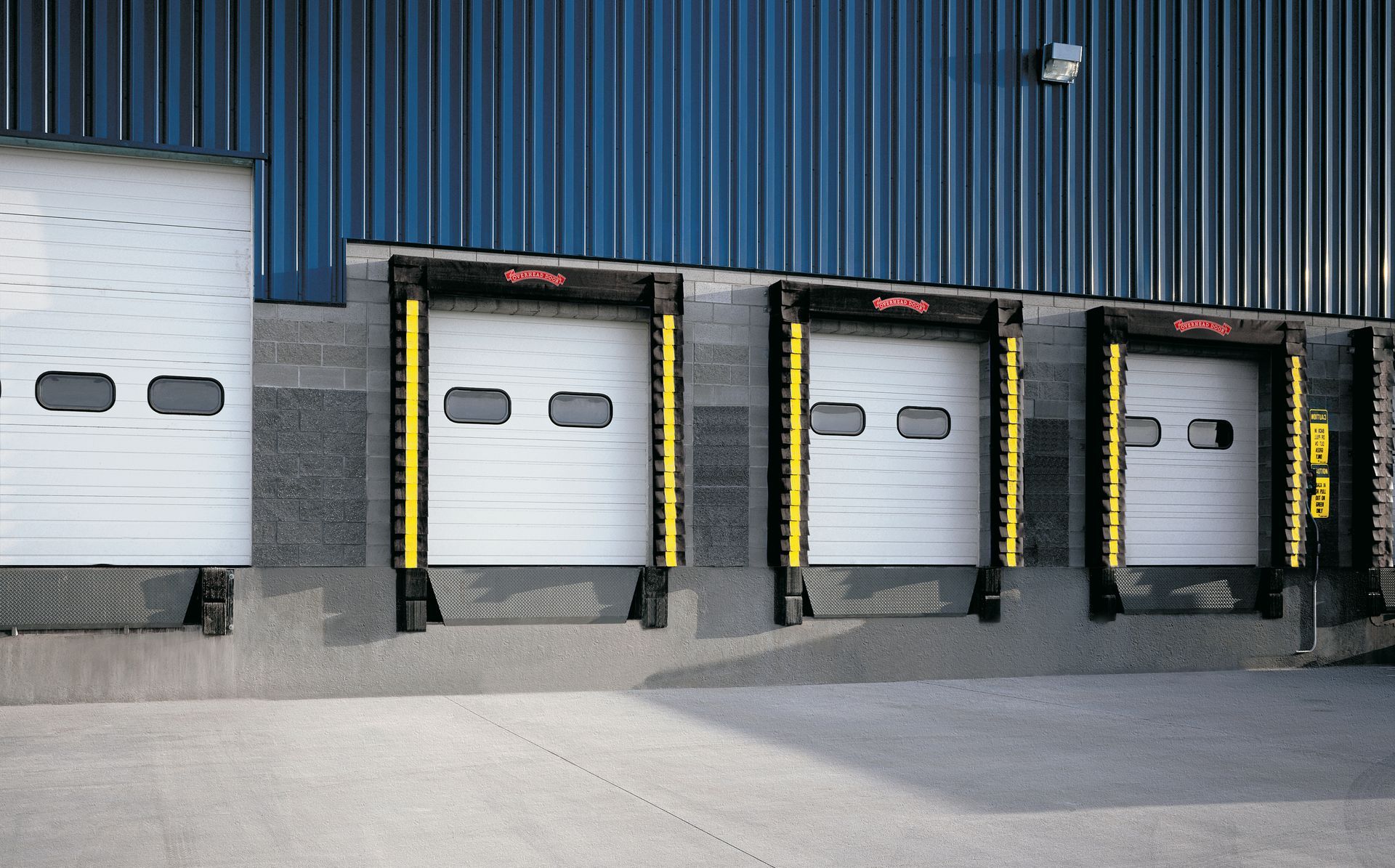 A row of loading docks are lined up in front of a building