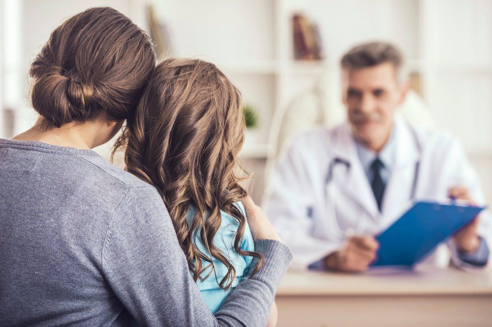 Little Girl With Her Mother At A Doctor On Consultation