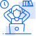 A man is sitting in front of a laptop computer with his hands on his head.