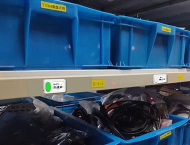 A warehouse filled with blue plastic bins filled with L112 Button-On
Wireless Light Tag.