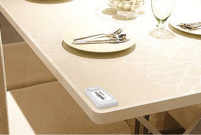 A dining table with plates and silverware on it L112 Button-On Wireless Light Tag