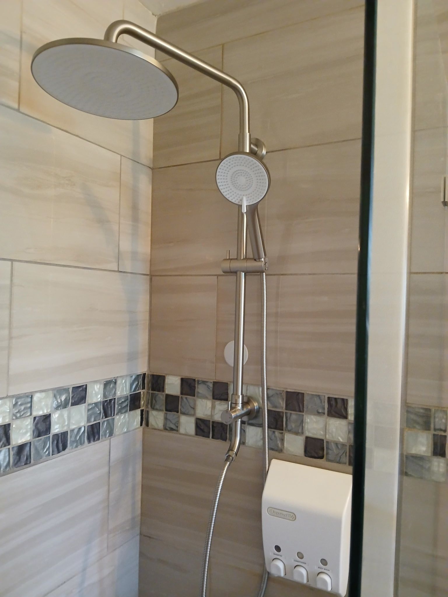 Modern tiled shower with chrome rainfall and handheld showerheads